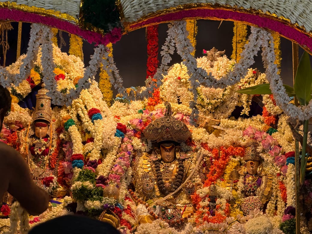Decorated deity inside an ancient Rameswaram temple sanctum adorned with flower garlands and lamps
