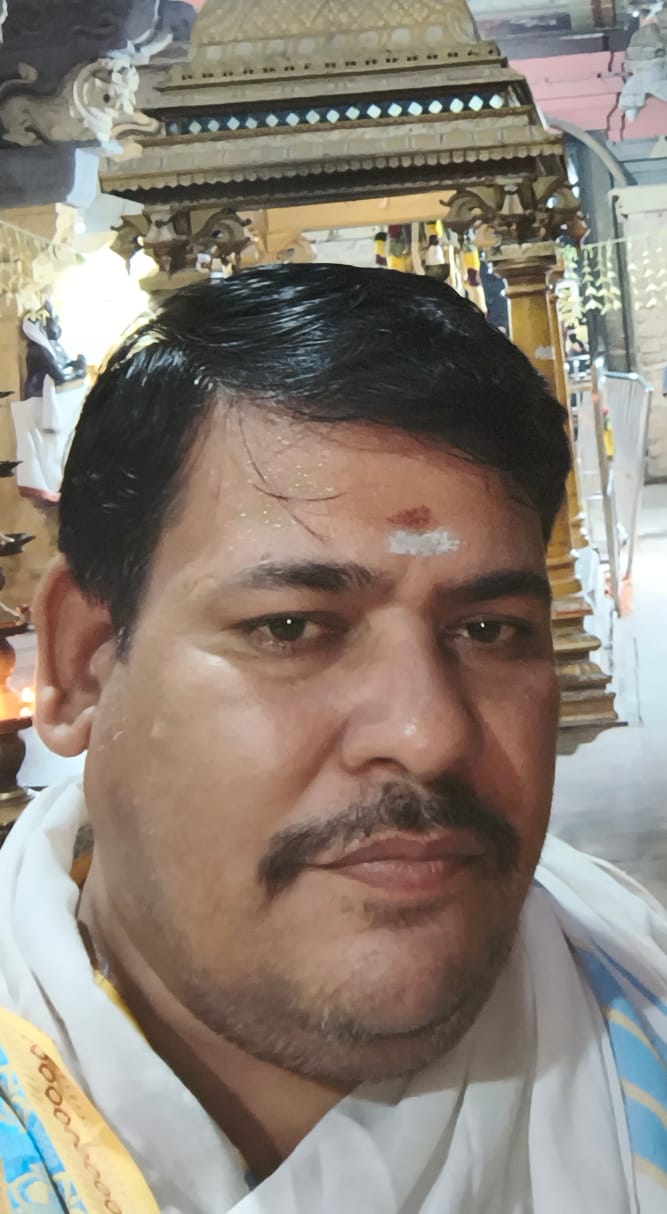 Pandit Pradeep Bhargava, traditional Vedic priest in Rameswaram, wearing saffron attire with sacred tilak